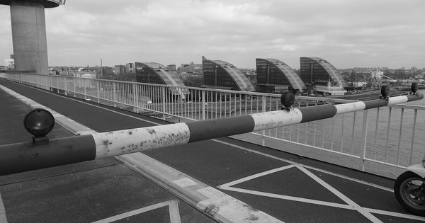 Closed traffic barrier gate across a roadway lane