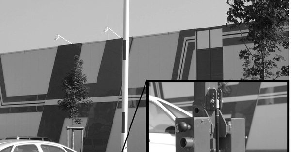 Close view of a raised barrier gate arm and gas-spring