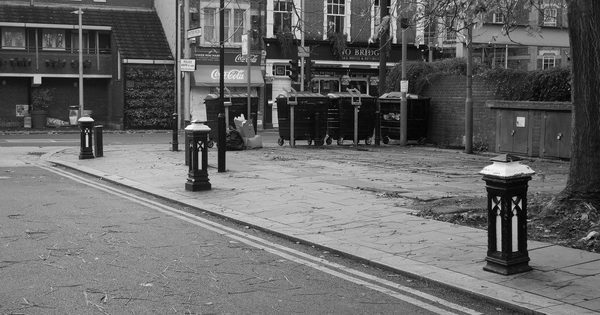 Row of fixed steel bollards guarding a vehicle access point
