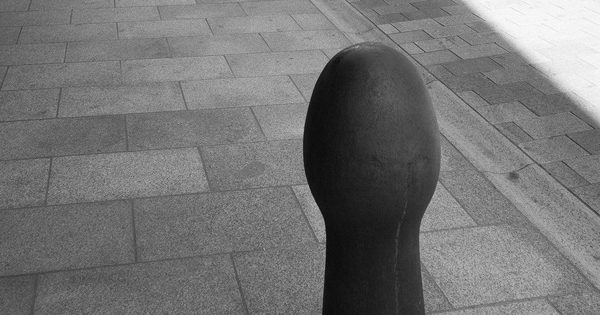 Row of cast iron bollards lining a street entrance