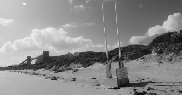 Automatic boom gates on an exposed coastal access road