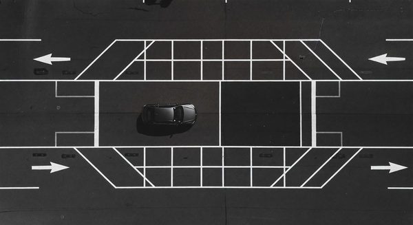 Aerial view of a barrier gate lane with striping and approach markings visible