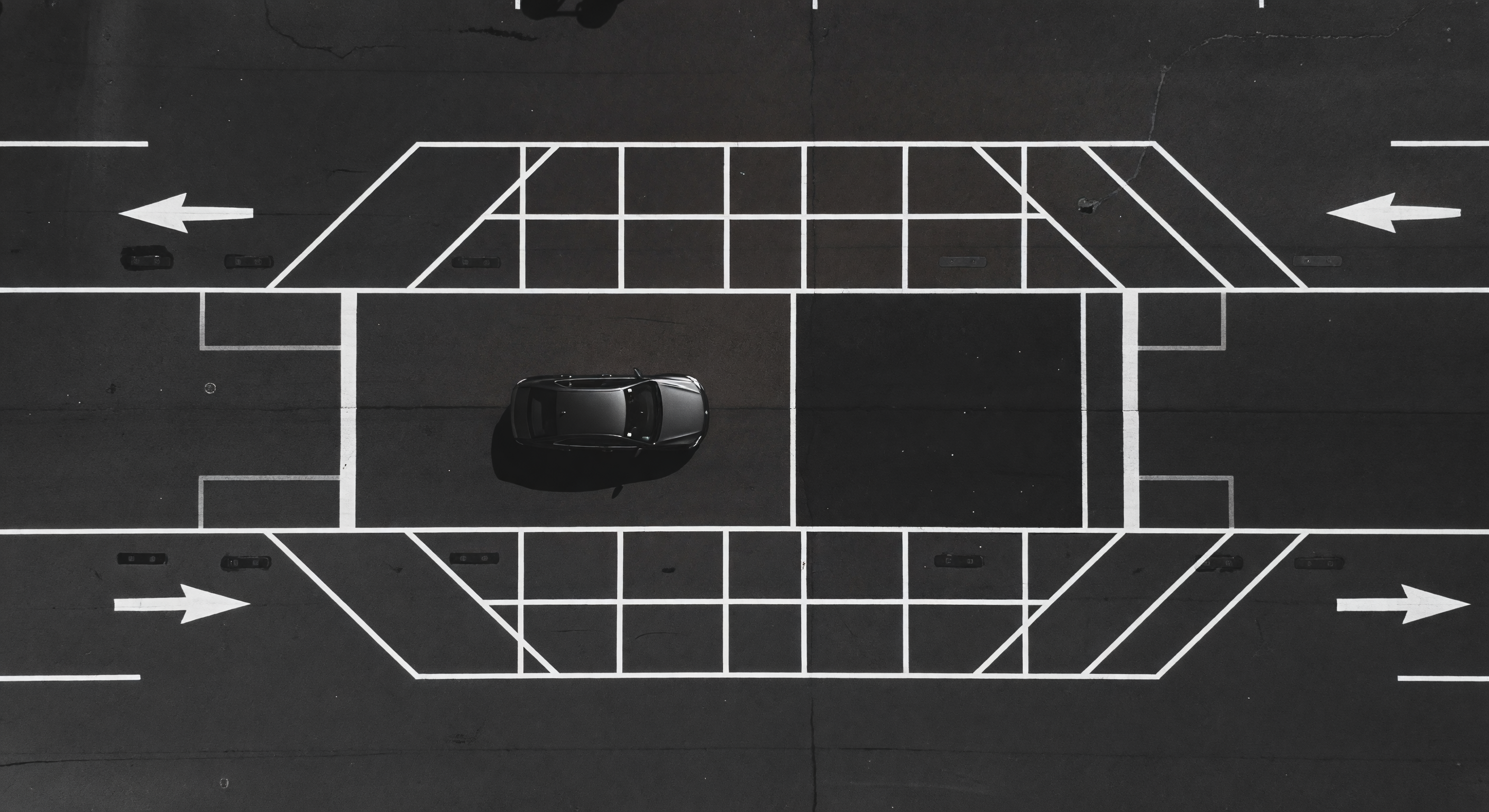 Aerial view of a barrier gate lane with striping and approach markings visible