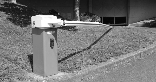 Broken barrier gate arm hanging loose after mechanical failure