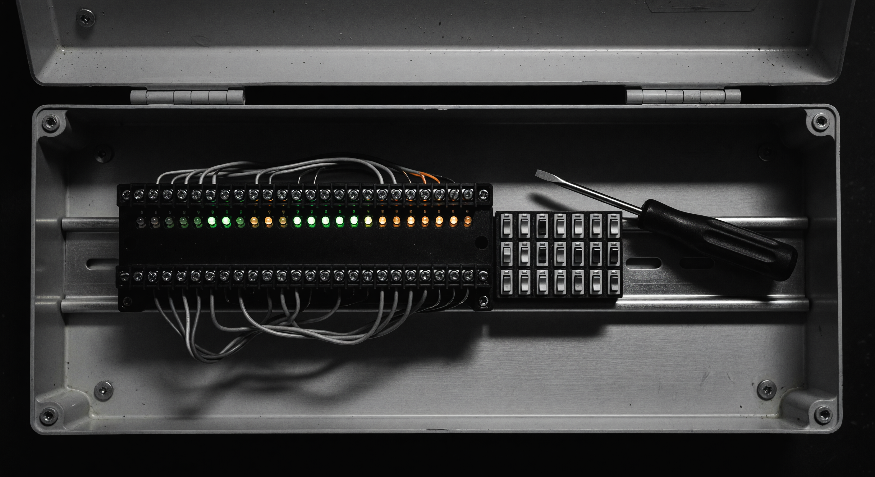 A loop detector control module mounted inside a gate cabinet with wiring terminals visible
